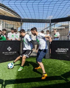 Two people playing panna football at the Crescent in Aldgate. You can partake in this for free until end of August 2026