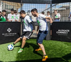 Two people playing panna football at the Crescent in Aldgate. You can partake in this for free until end of August 2026